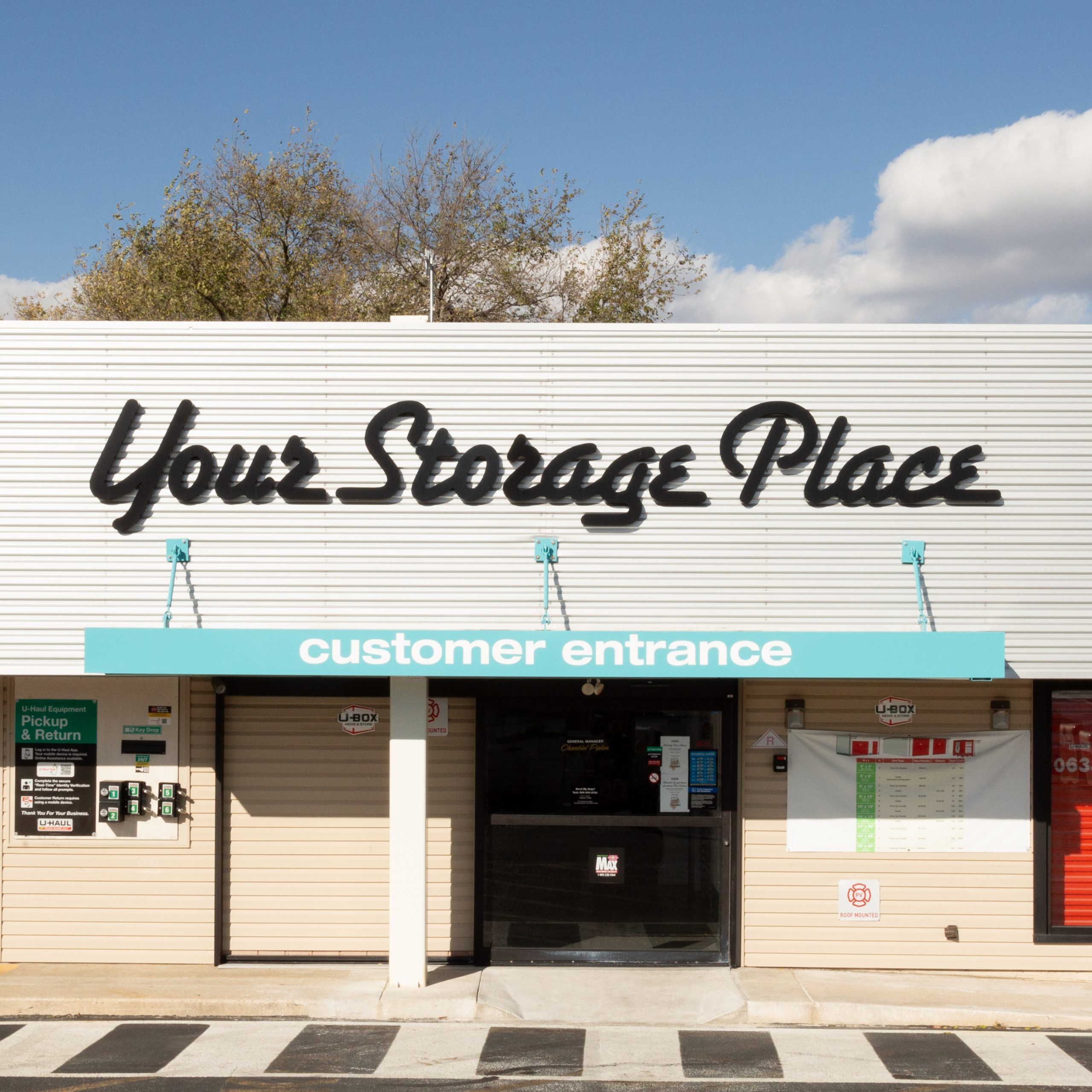 Your Storage Place customer entrance with signage and access points visible under a clear blue sky.